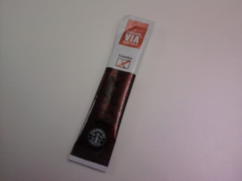 Starbucks Via Single serving packet of Via. Its a plastic pouch tube about 3 inches long with a perforated tear near the top.